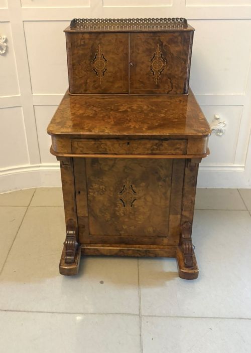 A Victorian burr walnut Davenport desk with floral marquetry inlay, a brass top gallery, and carved scroll feet. View XIV