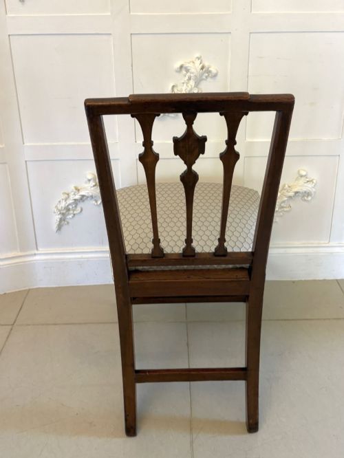 fig 2. A set of eight dark mahogany Victorian dining chairs with carved backs and light geometric patterned upholstered seats, including two carvers with armrests.