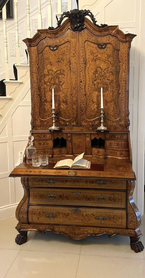 An 18th-century Dutch burr walnut bureau bookcase featuring intricate floral marquetry, a bombe lower drawer section, a fall-front desk slope, and an arched twin-door upper cabinet supported on claw feet. View VIII