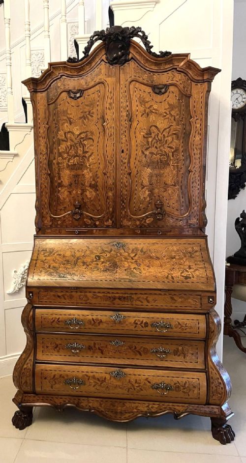 An 18th-century Dutch burr walnut bureau bookcase featuring intricate floral marquetry, a bombe lower drawer section, a fall-front desk slope, and an arched twin-door upper cabinet supported on claw feet. View XIV