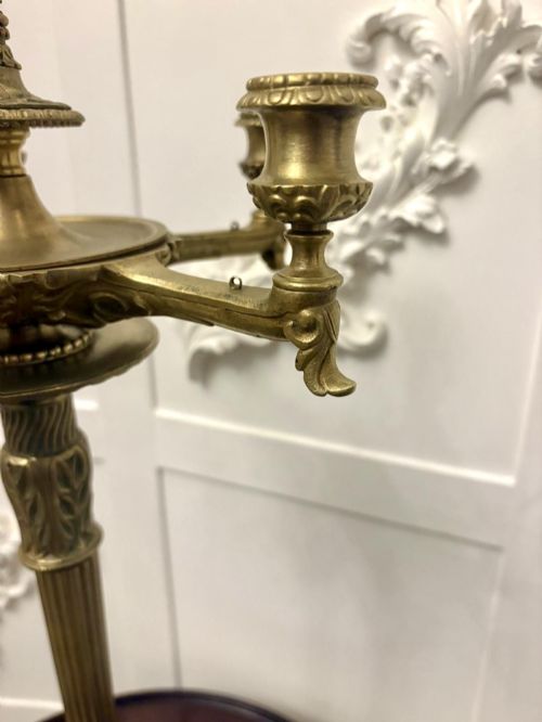 fig 1. An antique Victorian gilt brass six-light candelabrum featuring a fluted central stem, acanthus leaf motifs, and paw feet.