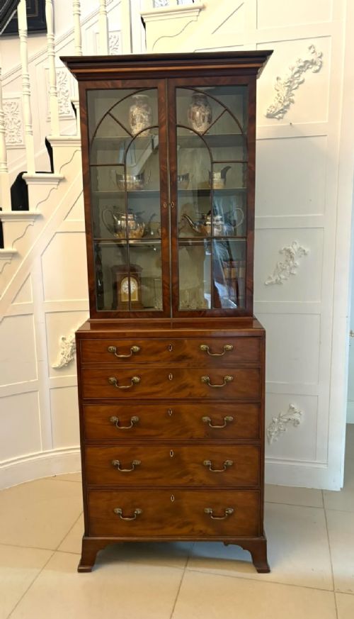 A tall Georgian mahogany secretaire bookcase featuring an upper cabinet with astragal glazed doors and a lower chest of drawers with brass handles. View VI