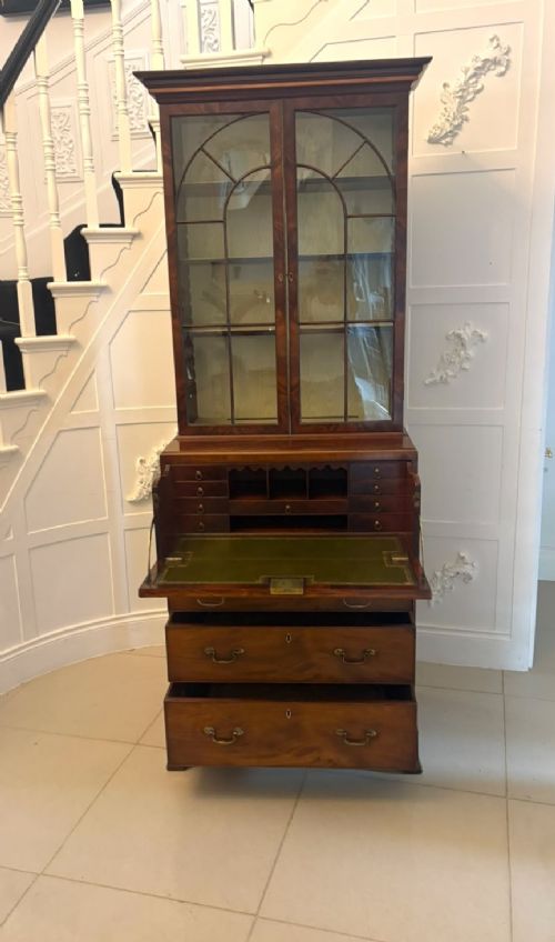 A tall Georgian mahogany secretaire bookcase featuring an upper cabinet with astragal glazed doors and a lower chest of drawers with brass handles. View XII