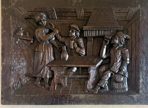 fig 2. A set of five square dark carved oak wall panels featuring detailed bas-relief scenes of figures in traditional Flemish tavern settings.
