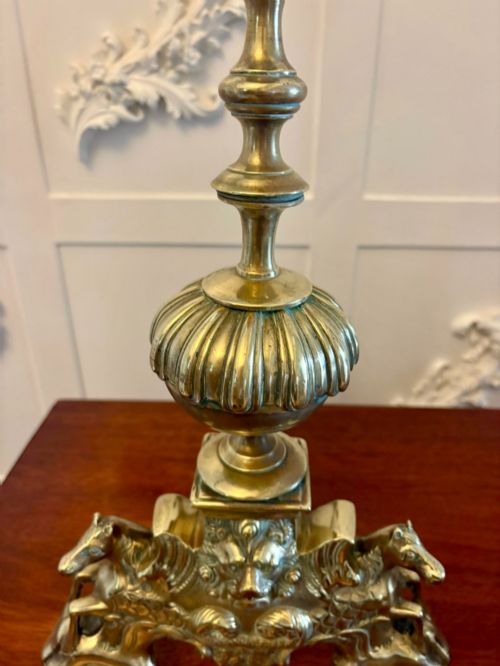 fig 3. A pair of ornate Victorian cast brass fire dogs featuring spiral-fluted finials, gadrooned central urns, and mythological horse motifs on the base.