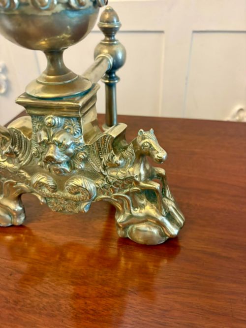 fig 4. A pair of ornate Victorian cast brass fire dogs featuring spiral-fluted finials, gadrooned central urns, and mythological horse motifs on the base.