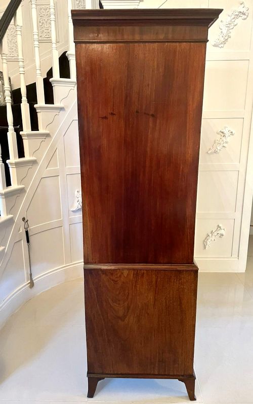 A tall George III figured mahogany chest on chest featuring two short drawers above five long drawers, fitted with oval brass drop handles and supported on bracket feet. View VIII