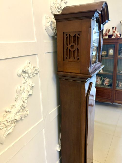 fig 3. An Edwardian mahogany longcase clock with satinwood urn inlay on the door and a brass dial with Tempus Fugit inscription.
