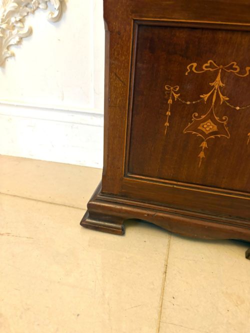 fig 6. An Edwardian mahogany longcase clock with satinwood urn inlay on the door and a brass dial with Tempus Fugit inscription.