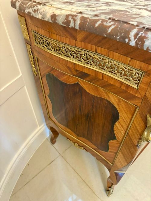 fig 1. An antique French style commode chest featuring a dark grey veined marble top, decorative walnut veneers, cast brass mounts, and cabriole legs.