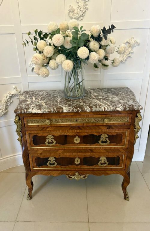 An antique French style commode chest featuring a dark grey veined marble top, decorative walnut veneers, cast brass mounts, and cabriole legs. View X