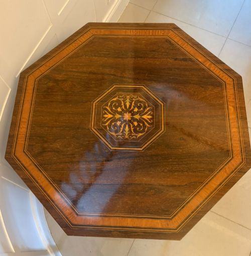 fig 1. An octagonal Victorian rosewood centre table with intricate central marquetry inlay, crossbanded borders, and spiral turned legs joined by a lower stretcher.