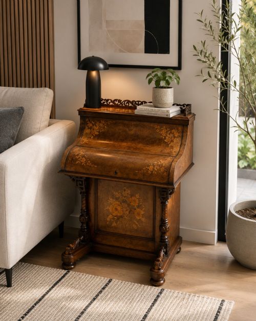 fig 1. A Victorian burr walnut piano top davenport desk featuring floral marquetry, side drawers with turned wooden knobs, and carved supports.