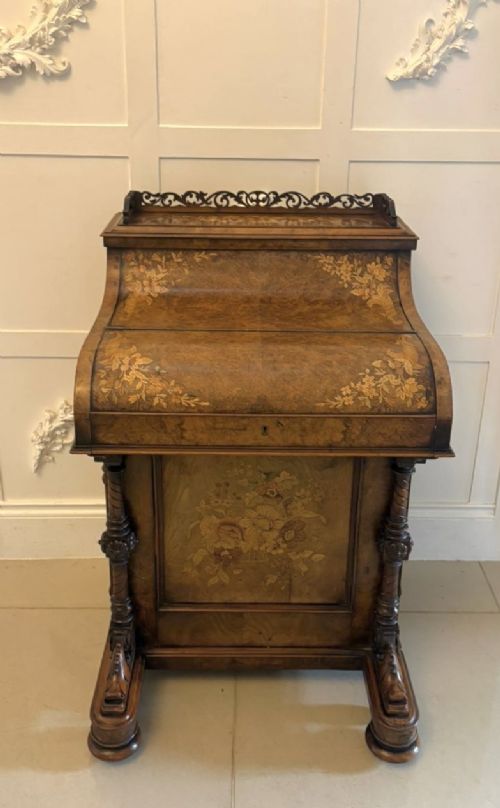 A Victorian burr walnut piano top davenport desk featuring floral marquetry, side drawers with turned wooden knobs, and carved supports. View XV