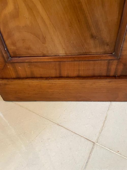 A William IV mahogany breakfront wardrobe featuring two tall outer cupboards flanking a central chest of three drawers with a carved gallery back. View III