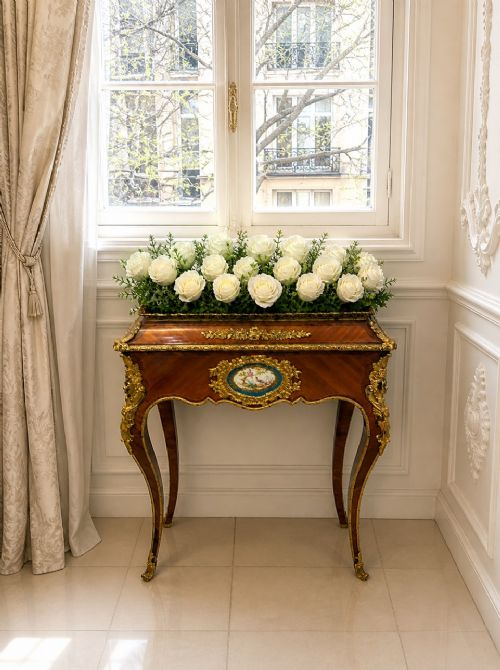 fig 1. A Louis XV style kingwood jardiniere stand with ornate gilt-bronze ormolu mounts, cabriole legs, and a central porcelain plaque.