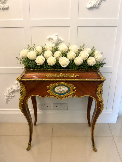 fig 2. A Louis XV style kingwood jardiniere stand with ornate gilt-bronze ormolu mounts, cabriole legs, and a central porcelain plaque.