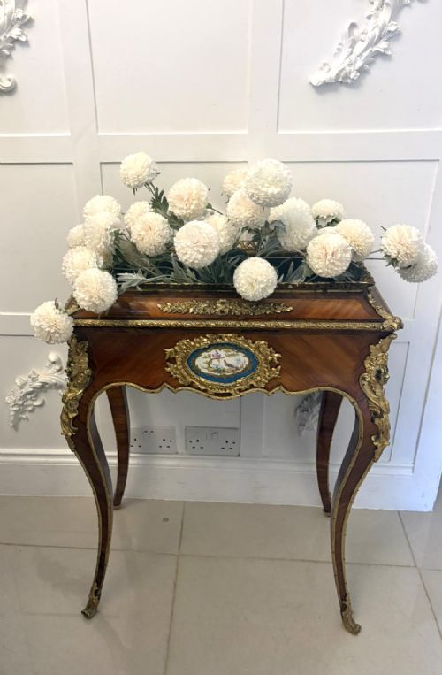 A Louis XV style kingwood jardiniere stand with ornate gilt-bronze ormolu mounts, cabriole legs, and a central porcelain plaque. View IX