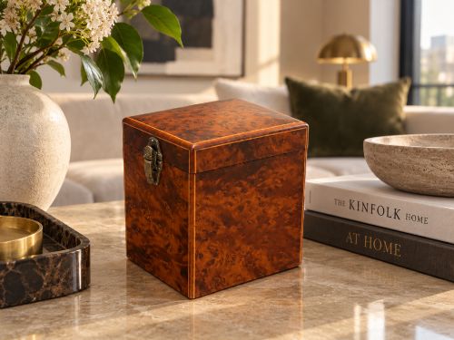 fig 1. An upright Victorian travelling tea caddy crafted from amboyna burl wood with line inlay and a brass front latch.