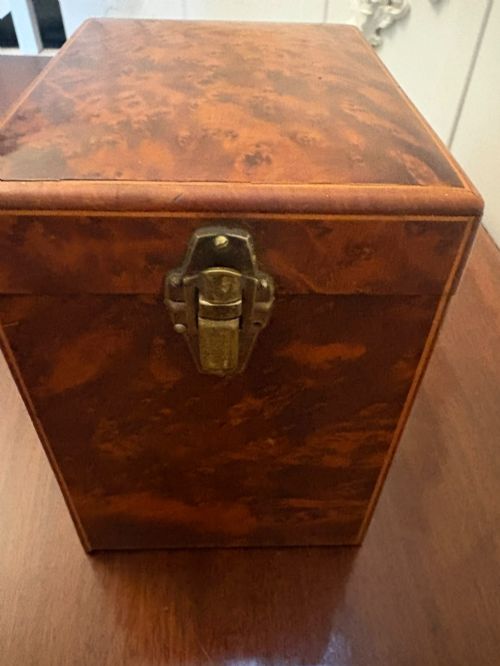 fig 3. An upright Victorian travelling tea caddy crafted from amboyna burl wood with line inlay and a brass front latch.