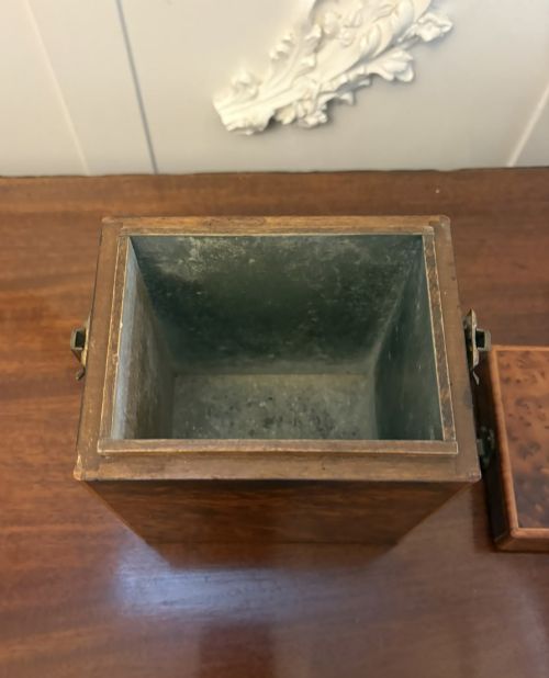 fig 4. An upright Victorian travelling tea caddy crafted from amboyna burl wood with line inlay and a brass front latch.