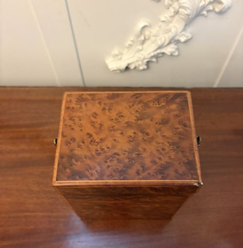 fig 6. An upright Victorian travelling tea caddy crafted from amboyna burl wood with line inlay and a brass front latch.