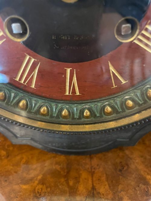 fig 3. A Regency bronze and marble clock set featuring a central figure-topped mantel clock flanked by a pair of three-branch candelabra.