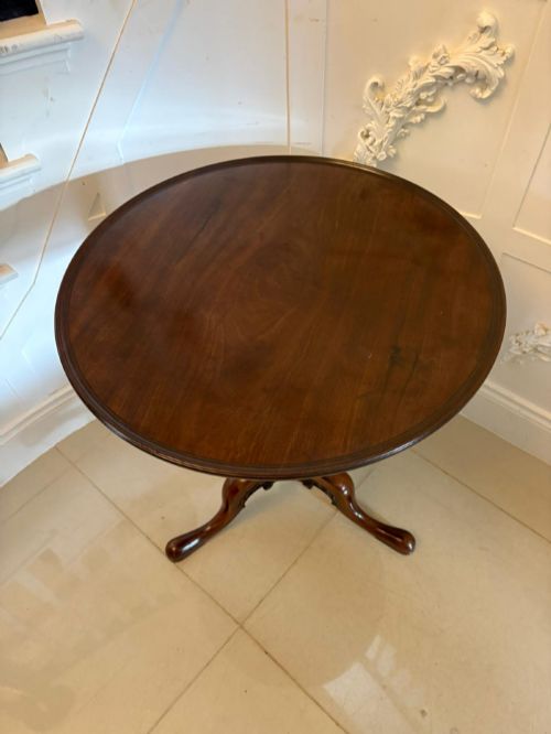 fig 1. A Georgian mahogany tripod table with a circular top mounted on a turned pedestal with three cabriole legs.