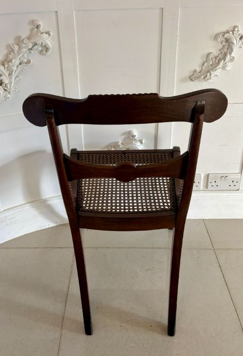 fig 1. A set of six Regency mahogany dining chairs featuring carved bar-back crest rails, rosettes, and green tartan fabric upholstery.