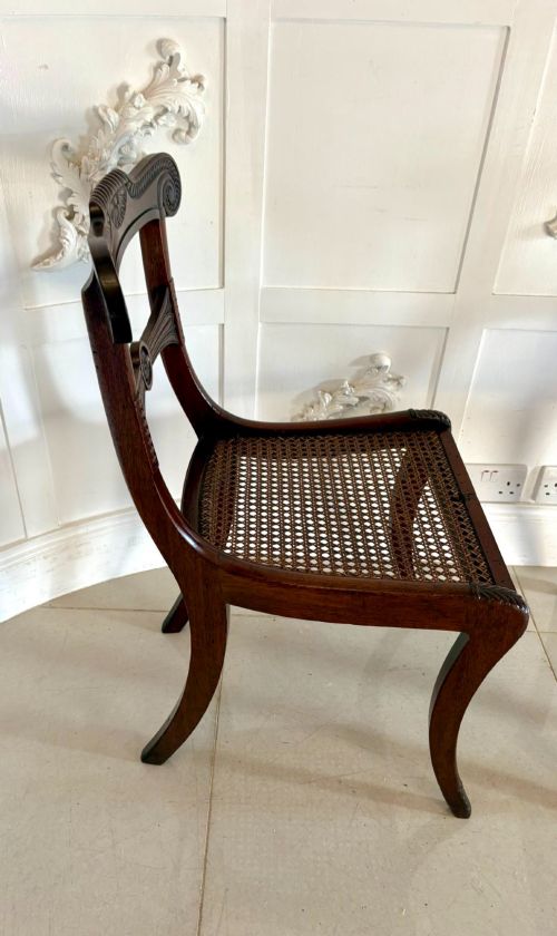 fig 2. A set of six Regency mahogany dining chairs featuring carved bar-back crest rails, rosettes, and green tartan fabric upholstery.