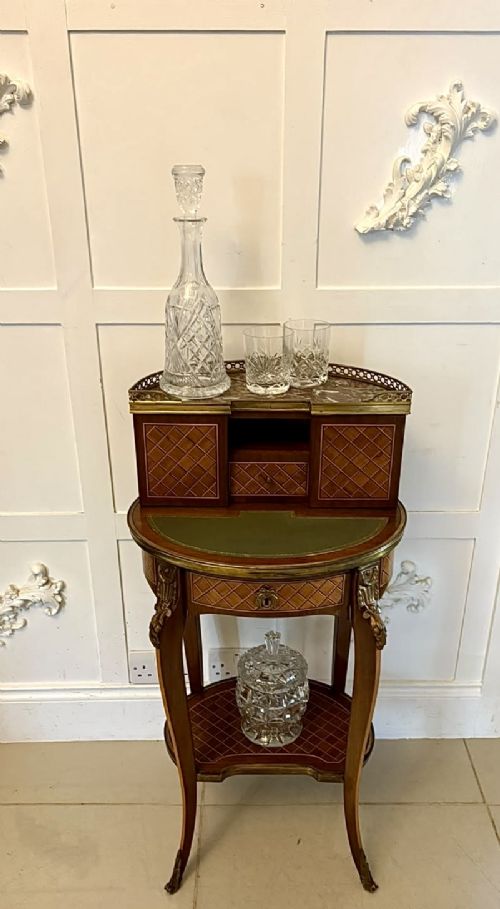 fig 3. A French kingwood parquetry bonheur du jour writing desk featuring a green leather inset, marble top gallery, and gilt-bronze mounts on slender cabriole legs.