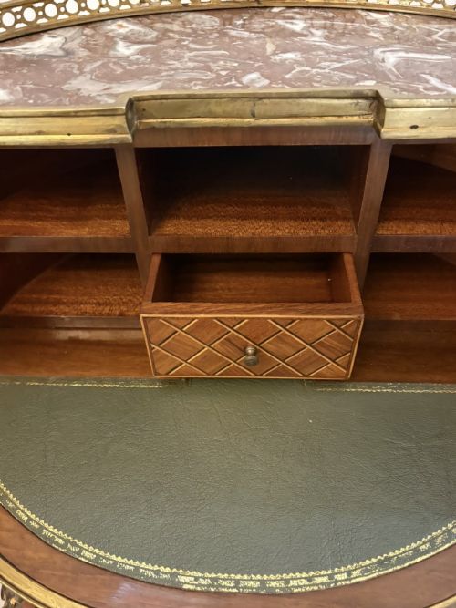 fig 4. A French kingwood parquetry bonheur du jour writing desk featuring a green leather inset, marble top gallery, and gilt-bronze mounts on slender cabriole legs.