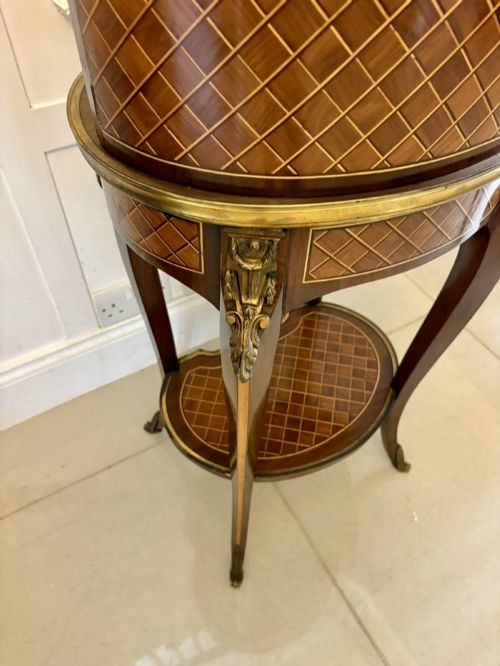 fig 7. A French kingwood parquetry bonheur du jour writing desk featuring a green leather inset, marble top gallery, and gilt-bronze mounts on slender cabriole legs.