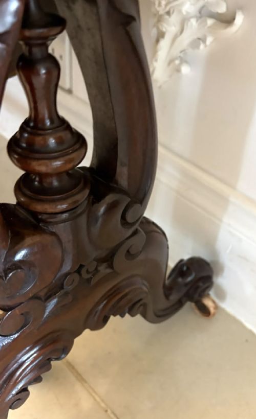 An antique Victorian rosewood Sutherland table with drop leaves, carved legs, and brass castors. View XII