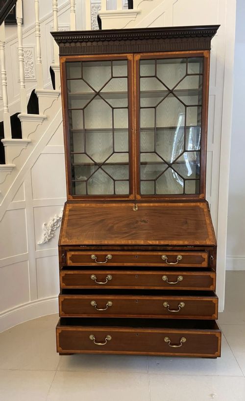 An 18th-century George III mahogany bureau bookcase featuring an upper astragal glazed cabinet above a slanted writing desk with four inlaid drawers and brass handles. View XIV