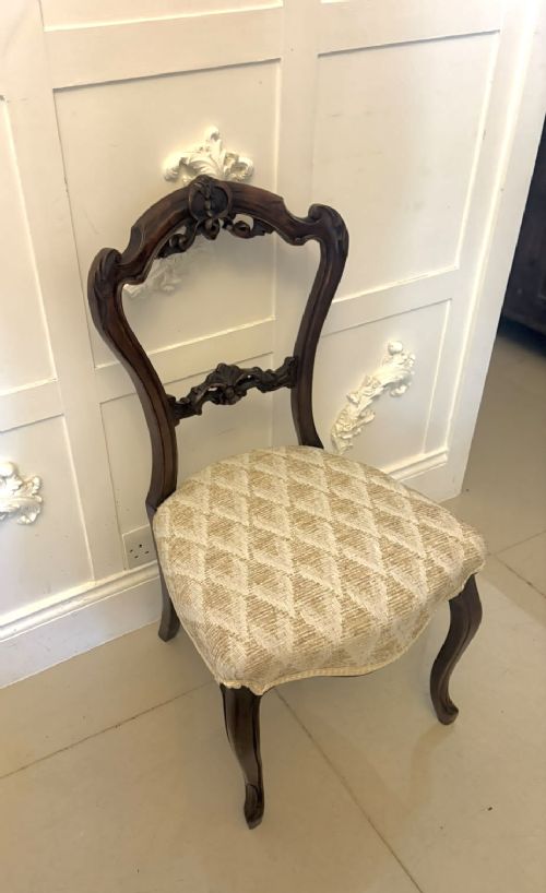 A set of four Victorian carved walnut dining chairs with open balloon-style backs and cream pattern-upholstered seats. View XI