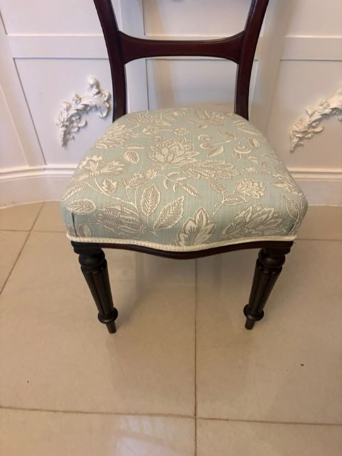 fig 1. Set of six Victorian mahogany dining chairs featuring curved open backrests, reeded front legs, and light blue pattern-upholstered seats.
