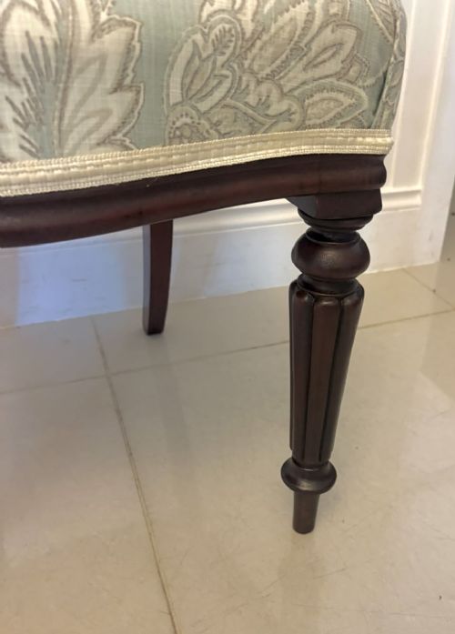 fig 2. Set of six Victorian mahogany dining chairs featuring curved open backrests, reeded front legs, and light blue pattern-upholstered seats.