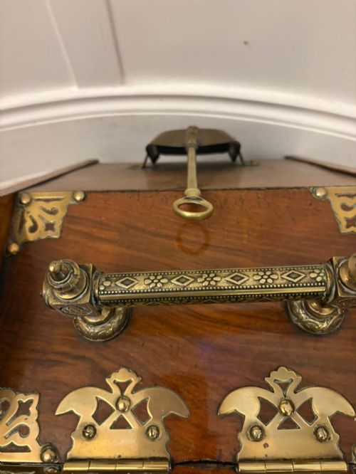 fig 1. A Victorian walnut coal purdonium featuring ornate decorative brass strap hinges, brass corner plates, and a top carrying handle.