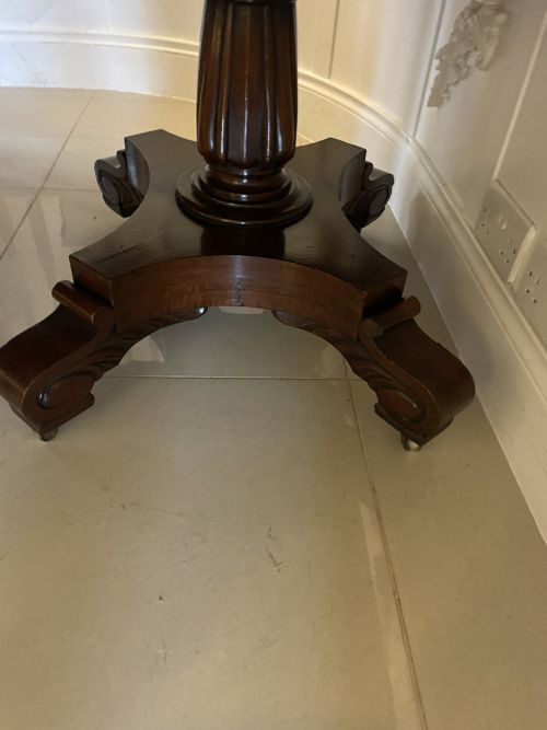 fig 1. An antique Regency extendable dining table crafted from polished figured mahogany with a pedestal base.