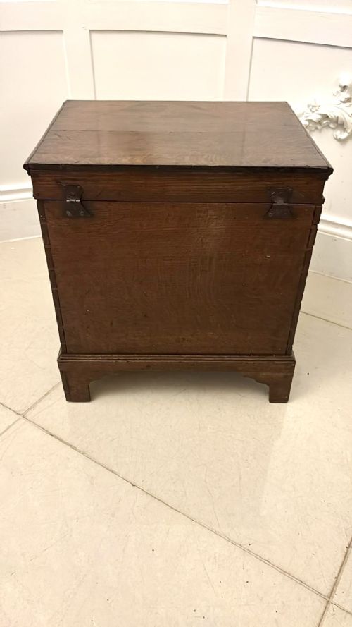 fig 1. An early 18th-century dark oak box coffer styled as a miniature chest of drawers with decorative brass escutcheons, ring handles, and bracket feet.