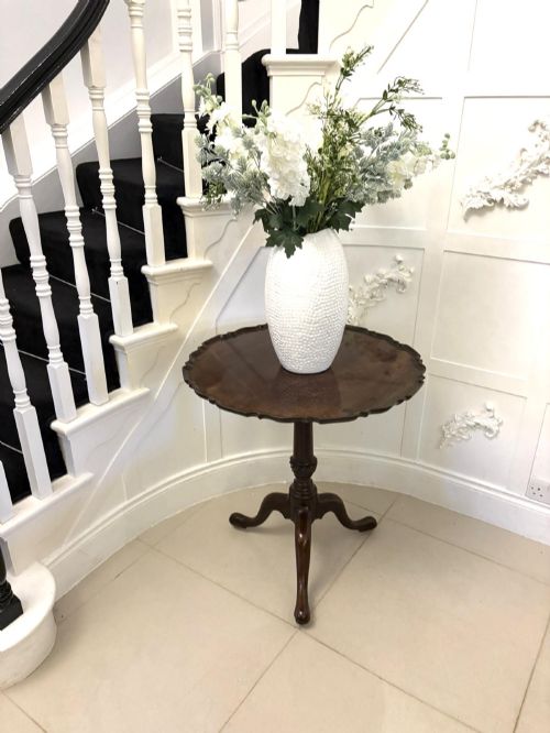fig 1. An 18th-century mahogany Chippendale tilt-top tripod table shown upright with a scalloped piecrust edge, turned column, and three cabriole legs.