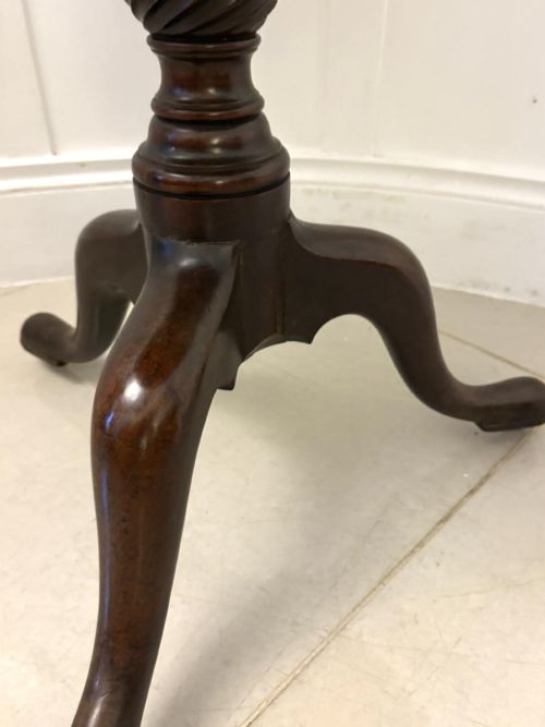 fig 2. An 18th-century mahogany Chippendale tilt-top tripod table shown upright with a scalloped piecrust edge, turned column, and three cabriole legs.