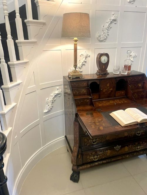 fig 1. An 18th-century style mahogany bombe bureau featuring floral marquetry inlay across the slant front and drawers, complete with brass handles and carved claw feet.