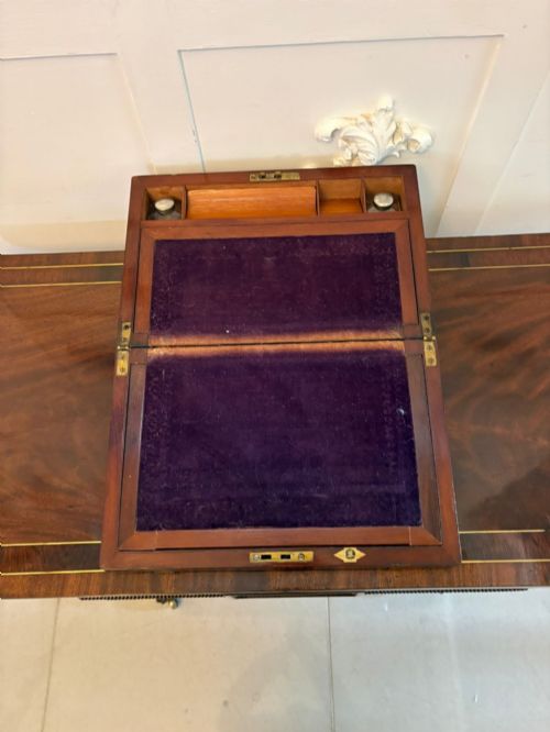 fig 1. A rectangular Victorian mahogany writing box featuring brass corner brackets, vertical brass strapping, a central brass shield inlay, and a brass keyhole escutcheon.