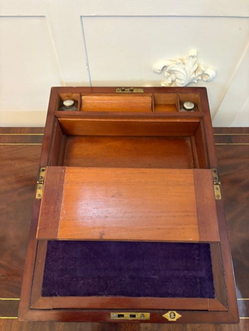 fig 2. A rectangular Victorian mahogany writing box featuring brass corner brackets, vertical brass strapping, a central brass shield inlay, and a brass keyhole escutcheon.