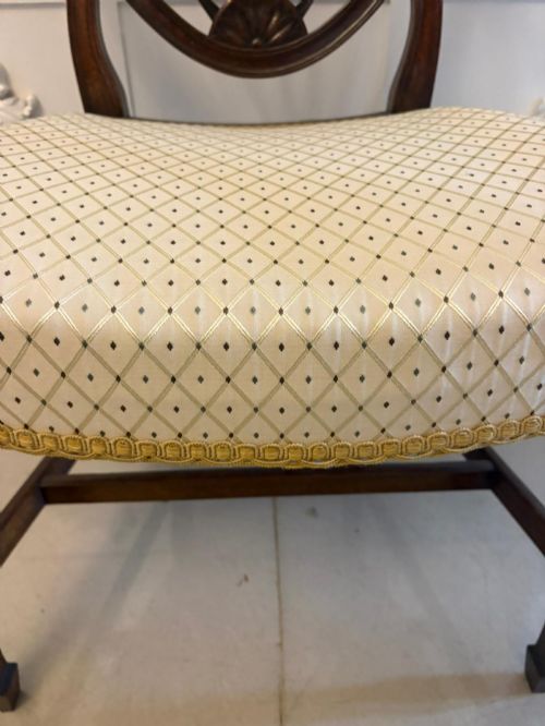 fig 1. A set of ten Edwardian mahogany shield-back dining chairs with cream geometric upholstered seats, including two carvers with curved arms.