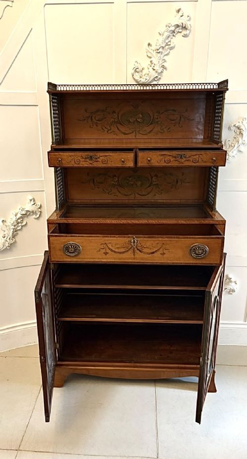 A Georgian Sheraton style satinwood display cabinet featuring upper open shelves with brass grilles and marquetry panels, positioned above a lower glazed twin-door cabinet with oval astragal bars. View XI