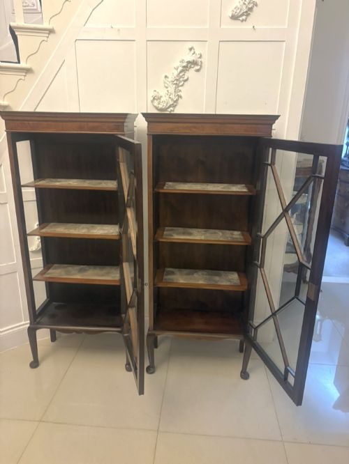 fig 2. A pair of tall Edwardian mahogany display cabinets with geometric astragal glazed glass doors and slender cabriole legs.