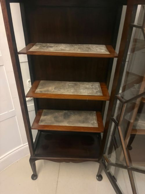 fig 3. A pair of tall Edwardian mahogany display cabinets with geometric astragal glazed glass doors and slender cabriole legs.